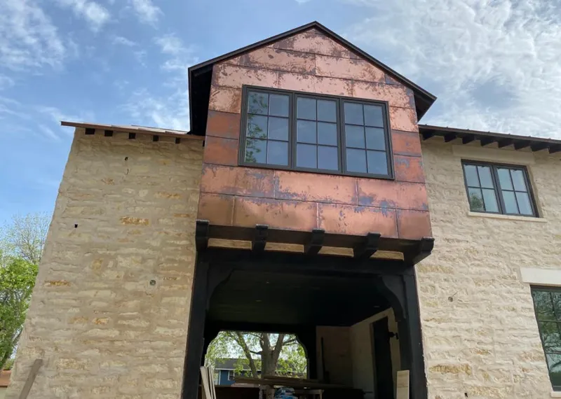 Copper metal panel facade on a stone building for Metal Roof Coating in Raisin