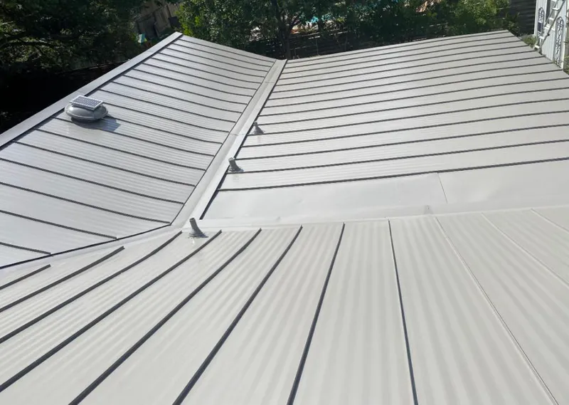Solar attic fan installed on a metal roof for Roof Ventilation in Raisin